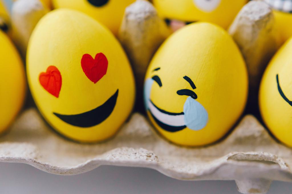 image of a laughing and love emoji. Photo by ROMAN ODINTSOV from Pexels